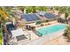 Beautiful backyard with a refreshing pool, patio with sunshade, and solar panels on the roof at 2426 La Pluma St, Henderson, NV 89014