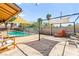 Lush backyard featuring a swimming pool, shaded patio, and ample seating at 2426 La Pluma St, Henderson, NV 89014