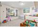 Bedroom with window views, neutral tones, filled with playful toys at 2426 La Pluma St, Henderson, NV 89014