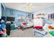 Whimsical bedroom featuring vibrant blue walls, playful decorations, and comfortable sleeping arrangements at 2426 La Pluma St, Henderson, NV 89014