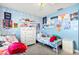 Charming bedroom with playful decor, featuring twin beds, colorful wallpaper, and ample natural light at 2426 La Pluma St, Henderson, NV 89014