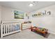 Bedroom with neutral tones, dresser, filled with playful toys, and carpet flooring at 2426 La Pluma St, Henderson, NV 89014