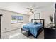 Comfortable bedroom with a ceiling fan and a window providing natural light, creating a relaxing atmosphere at 2426 La Pluma St, Henderson, NV 89014