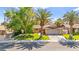 Charming single-story home featuring a well-manicured lawn, mature trees, and a two-car garage at 2426 La Pluma St, Henderson, NV 89014