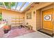 Inviting front porch with potted plants, a small bench, and a decorative door at 2426 La Pluma St, Henderson, NV 89014