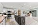 Expansive kitchen features white cabinetry, a stainless steel refrigerator, and a dark center island at 2426 La Pluma St, Henderson, NV 89014