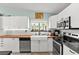 Modern kitchen featuring white cabinets, butcher block countertops, stainless steel appliances, and a farmhouse sink at 2426 La Pluma St, Henderson, NV 89014