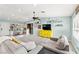 Bright living room with a ceiling fan and decorative display shelves above a yellow media center at 2426 La Pluma St, Henderson, NV 89014