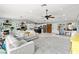 Bright, open living room featuring a stone fireplace, ceiling fan, and gray rug at 2426 La Pluma St, Henderson, NV 89014