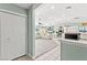Bright, open living room with tile flooring, white sofas, and natural light throughout at 2426 La Pluma St, Henderson, NV 89014