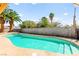 Refreshing backyard pool with a concrete surround and privacy wall, perfect for summer relaxation at 2426 La Pluma St, Henderson, NV 89014