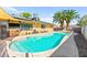 Sparkling pool is the focal point of the backyard oasis, surrounded by lounge chairs and lush landscaping at 2426 La Pluma St, Henderson, NV 89014