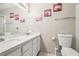 Bathroom features a double vanity, decorative lighting, shower, and artwork at 2460 Old Forge Ln # 48, Las Vegas, NV 89121