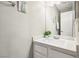 Bright bathroom features a quartz countertop vanity and a shower at 2460 Old Forge Ln # 48, Las Vegas, NV 89121