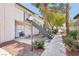 Attractive exterior showing walkways, balconies, mature trees, and manicured landscaping at 2460 Old Forge Ln # 48, Las Vegas, NV 89121