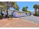 Exterior of building with desert landscaping, shrubs, and mature trees at 2460 Old Forge Ln # 48, Las Vegas, NV 89121