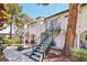 Exterior view of building showcasing walkways, balconies, and mature trees at 2460 Old Forge Ln # 48, Las Vegas, NV 89121