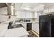 Updated kitchen features white cabinets, modern appliances, and quartz countertops at 2460 Old Forge Ln # 48, Las Vegas, NV 89121