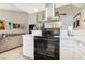 Bright kitchen features white cabinets, quartz countertops, and stainless steel range hood at 2460 Old Forge Ln # 48, Las Vegas, NV 89121