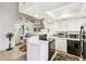 Modern kitchen open to living area, features white cabinets and stainless hood at 2460 Old Forge Ln # 48, Las Vegas, NV 89121