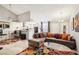 Open-concept living room features a kitchen view and comfortable seating at 2460 Old Forge Ln # 48, Las Vegas, NV 89121
