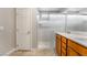 Bathroom featuring double sinks, white countertop, a shower with sliding glass doors and tile flooring at 2871 Tanager Hill St, Henderson, NV 89044