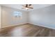 Bright bedroom with hard wood flooring, a ceiling fan and a window with a view at 2871 Tanager Hill St, Henderson, NV 89044