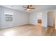 Bedroom with neutral walls, wood-look floors, ceiling fan, and a bright window at 2871 Tanager Hill St, Henderson, NV 89044