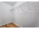 Walk-in closet with white wire shelving and wood-look floors at 2871 Tanager Hill St, Henderson, NV 89044
