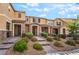 Inviting townhome showcasing lush front yard landscaping and brick walkway at 2871 Tanager Hill St, Henderson, NV 89044