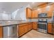 Bright kitchen with stainless steel appliances, wood cabinets, granite countertops, and modern fixtures at 2871 Tanager Hill St, Henderson, NV 89044