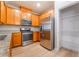 Kitchen with stainless steel appliances, wood cabinets, granite countertops, and an open pantry at 2871 Tanager Hill St, Henderson, NV 89044