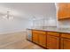 Open concept kitchen with granite countertops, stainless steel dishwasher, and light wood-look floors at 2871 Tanager Hill St, Henderson, NV 89044