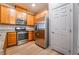 Spacious kitchen featuring stainless steel appliances, light cabinets, and wood-look floors at 2871 Tanager Hill St, Henderson, NV 89044