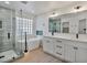 Bright bathroom featuring a freestanding tub, tiled shower, and double sink vanity with modern black fixtures at 2894 Matese Dr, Henderson, NV 89052