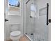 A modern bathroom featuring a toilet and enclosed shower with light tile at 2894 Matese Dr, Henderson, NV 89052