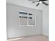 This bedroom has hardwood floors, a ceiling fan, and a window with translucent glass at 2894 Matese Dr, Henderson, NV 89052