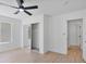A bedroom showcasing hardwood floors, a large window, ceiling fan, and mirrored closet doors at 2894 Matese Dr, Henderson, NV 89052