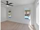 Bright bedroom with a ceiling fan and multiple windows overlooking the pool at 2894 Matese Dr, Henderson, NV 89052
