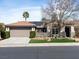 Attractive single-story home with solar panels, a tile roof, a two-car garage and manicured landscaping at 2894 Matese Dr, Henderson, NV 89052