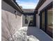 A small patio is surrounded by stucco walls and features dark framed doors and a tile roof at 2894 Matese Dr, Henderson, NV 89052