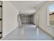 Spacious and clean two-car garage with a shiny epoxy floor and a window for natural light at 2894 Matese Dr, Henderson, NV 89052