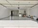 Spacious garage with epoxy flooring, ample storage space, and room for parking vehicles at 2894 Matese Dr, Henderson, NV 89052