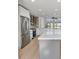 A spacious kitchen features white cabinets, stainless steel appliances, a gray island, and light wood-look floors at 2894 Matese Dr, Henderson, NV 89052