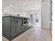 A gray kitchen island features cabinets, drawers, stainless oven, and a white countertop in a brightly lit space at 2894 Matese Dr, Henderson, NV 89052