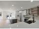 An open concept kitchen boasts stainless appliances, a gray kitchen island, and white countertops at 2894 Matese Dr, Henderson, NV 89052