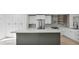 Modern kitchen featuring white cabinets, a center island and stainless appliances at 2894 Matese Dr, Henderson, NV 89052