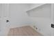 Neutral-toned laundry room with wood-look flooring and built-in shelving at 2894 Matese Dr, Henderson, NV 89052