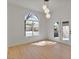 Bright living room with hardwood floors, arched window and glass doors to the backyard at 2894 Matese Dr, Henderson, NV 89052
