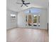 Bright living room with high ceilings, light wood-look floors, and a view of the outdoor space at 2894 Matese Dr, Henderson, NV 89052